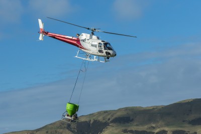 Helicopter with a hopper carrying out an aerial 1080 operation